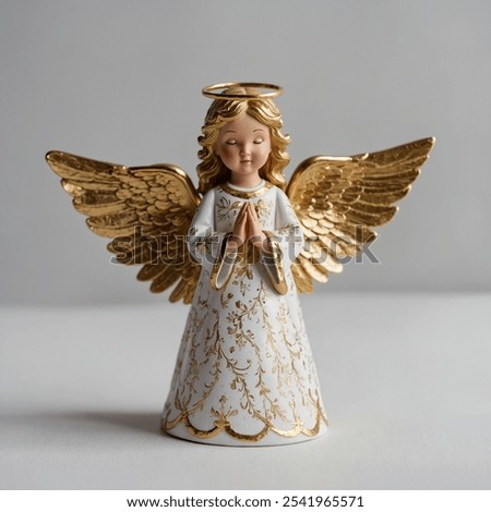 This elegant Christmas angel figurine features delicate golden wings, symbolizing peace and grace. 