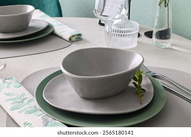 This elegant table setting with modern dinnerware and minimal decor enhances the experience - Powered by Shutterstock