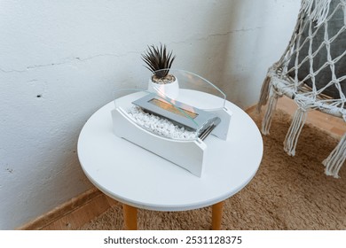 This elegant white table, which showcases a lovely green plant alongside an intriguing book, truly adds charm and an undeniable style to any room, beautifully enhancing the overall decor of your home
