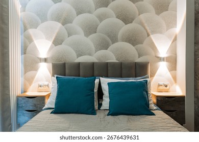 This is an elegantly designed bedroom featuring a comfortable bed, matching nightstands, and a stylish wall adorned with beautiful patterned wallpaper, creating a cozy and inviting atmosphere