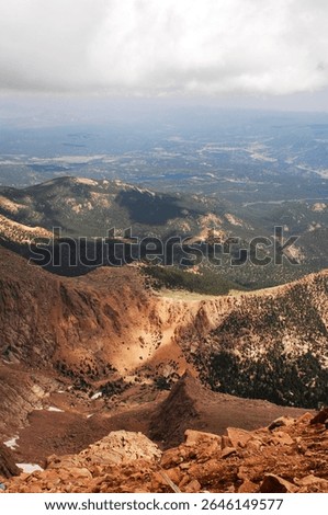 This elevated view captures the lush valleys nestled between lofty peaks, highlighting the serene beauty and breathtaking scale of the mountainous landscape.