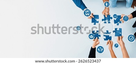 This engaging image captures a collaborative business environment where hands connect puzzle pieces, symbolizing teamwork and strategic management efforts towards shared goals. Amity
