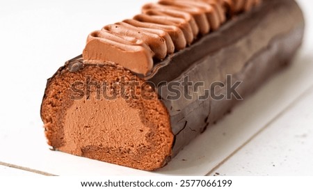 This exquisite chocolate dessert features a smooth chocolate mousse layered with a dense chocolate sponge, elegantly finished with piped chocolate ganache. A perfect blend of textures and rich flavors
