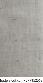 This fabric appears to be a light-colored dobby-woven textile featuring a subtle grid pattern enhanced by small raised textured details. The intricate weave creates a soft, dimensional surface that adds visual interest while maintaining an elegant and understated appearance. Its neutral tone and refined texture make it suitable for a variety of applications, including apparel, upholstery, curtains, table linens, and decorative home furnishings. The durable woven construction provides both style and versatility, making it a popular choice for contemporary and classic interior designs alike.