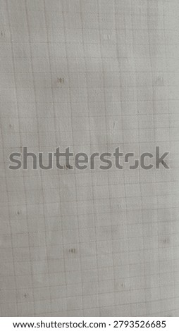 This fabric appears to be a light-colored dobby-woven textile featuring a subtle grid pattern enhanced by small raised textured details. The intricate weave creates a soft, dimensional surface that adds visual interest while maintaining an elegant and understated appearance. Its neutral tone and refined texture make it suitable for a variety of applications, including apparel, upholstery, curtains, table linens, and decorative home furnishings. The durable woven construction provides both style and versatility, making it a popular choice for contemporary and classic interior designs alike.