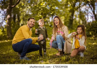 This family knows how to have fun. Parents spending time with their children outside. - Shutterstock ID 1735539500