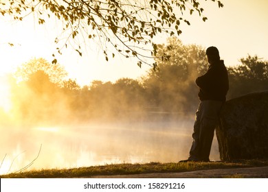 This foggy morning and quite lake makes for an inspirational location for this adult male to contemplate life's challenges and rewards in a quiet setting.