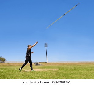 this is going the distance. Shot of a lone man throwing a javelin outside. - Powered by Shutterstock