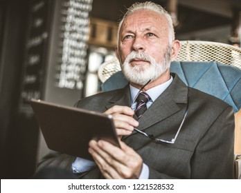  This Is A Great Way To Get The Job Done. Senior Business Man Using Digital Tablet. Close Up.