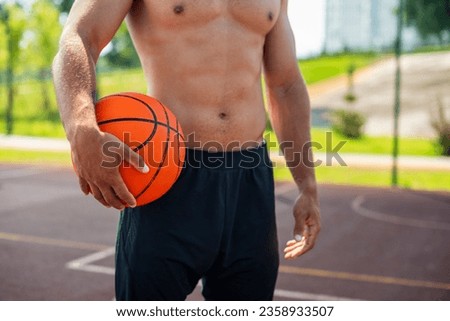 This heartwarming photograph captures the pure and unbridled joy of a man as he holds a basketball in his hands