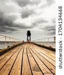 This High Dynamic Range (HDR) picture shows off the patched, rusting and weather-worn appearance of this sea-front pier in Whitby, (Yorkshire, UK), and the dramatic clouds in the sky.