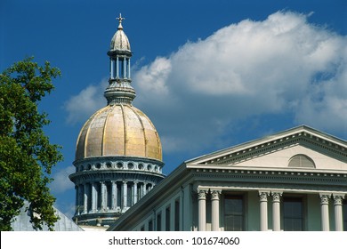 This is the historic State Capitol building in New Jersey. It has a yellow dome and columns making up the structure.