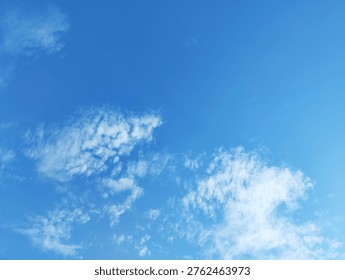 This horizontal frame captures a bright blue atmosphere with several small cloud clusters spread across the lower half.
The formations vary in size, some appearing as tight groups of specks while others form looser patches.
The upper portion remains clear, emphasising vertical space and openness.
Daylight from above intensifies the blue field and accentuates the white tops of each fragment.
The shapes suggest altocumulus or young cumulus elements in settled conditions.
No landscape or structures are included, allowing the viewer to focus solely on atmospheric patterns.
The distribution of clusters adds rhythm while remaining balanced and non‑chaotic.
Designers can place text in the upper clear zone or weave it between the lower groups.
The scene can convey themes of lightness, ideas forming, or conversation bubbles.
The cool, crisp palette fits well with technological, creative, and wellness communications.
The mood is positive and relaxed, with no sign of threatening weather.
Main subject: multiple small clusters of white cloud floating in bright blue atmosphere under strong natural daylight with light, playful mood.