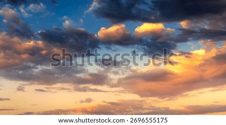 This is a horizontal photograph capturing a dynamic and colorful sky, most likely during sunrise or sunset.