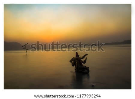 This image is captured near Bramhaputra River From Assam , India . It shows a Statue of Godess Floating near the river during sunset.  I took this picture with a long exposure settings . 