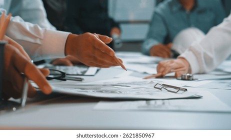 This image captures a dynamic brainstorming session where hands meticulously work on sketches and designs, reflecting collaboration, creativity, and innovative thinking. SACTR