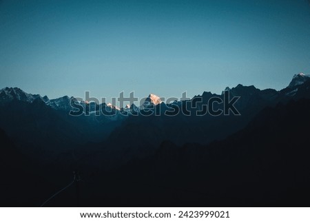 This image captures the Himalayan peak of Hathi Parbat, or the Elephant Peak, in Chamoli, Uttarakhand, India. This evening view was taken from Auli in Uttarakhand.