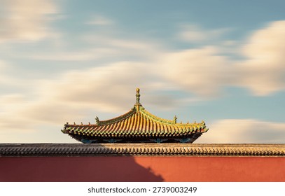 This image captures the iconic red wall and golden glazed tile roof of Shenyang Imperial Palace, a masterpiece of traditional Chinese imperial architecture from the Qing Dynasty. The upturned eaves are adorned with mythical beast sculptures, while the long-exposure technique creates soft, flowing clouds against the warm dusk light. This historic landmark, a UNESCO World Heritage site, embodies the grandeur of ancient Chinese imperial culture and is a renowned destination for cultural tourism and architectural photography in Northeast China.