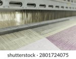 This image captures the intricate process of weaving at a wool production factory, showcasing the spinning machine in action for textile manufacturing.