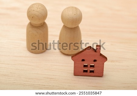 This image could symbolize a couple husband and wife considering buying a home or a family who has recently purchased a house.