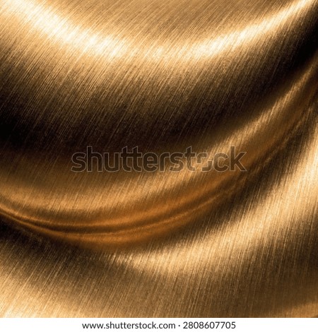 This image depicts a brushed metallic surface, featuring flowing lines and a warm gold color. The texture exhibits subtle light reflections and a smooth finish.