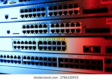 This image depicts a close-up of multiple network switches with numerous Ethernet ports, illustrating a critical component of modern digital communication infrastructure.