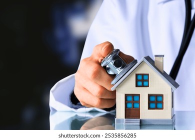 This image depicts a healthcare professional placing a stethoscope on a small model of a house, symbolizing the concept of "house health" or a "home check-up." It reflects the ideas of home inspection - Powered by Shutterstock