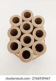 This image displays a bundle of ten parallel-wound, brown paper tubes, held together by a rubber band. These tubes typically serve as components in pyrotechnics, specifically identified as being suitable for building small fireworks such as rockets, fountains, whistles, or drivers. The specific tubes in the image are consistent with a 4-ounce size, featuring an internal diameter of approximately half inch and a length of around 2.5 inches. Their sturdy, multi-layered construction is designed to withstand the internal pressures generated during the ignition of propellants or compositions. 