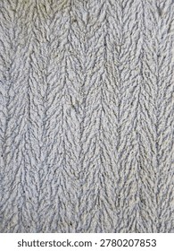 This image displays a close-up of a surface featuring a herringbone pattern, a classic design characterized by its distinctive V-shape or 