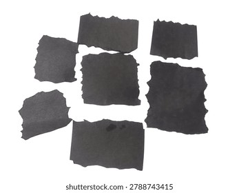 This image features an abstract composition of irregular dark shapes on a light background. The shapes vary in size and form, creating a visually intriguing pattern. The dark shapes are scattered across the image, with some overlapping and others spaced apart, giving a sense of depth and dimension.