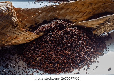 This image features Amazonian cacao nibs beautifully presented on a sebucán, a traditional woven press used to process cassava.