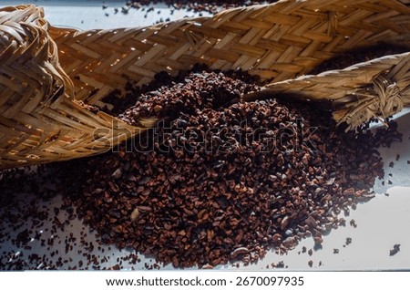 This image features Amazonian cacao nibs beautifully presented on a sebucán, a traditional woven press used to process cassava.