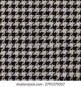 This image features a close-up, top-down view of a classic houndstooth textile pattern. The fabric displays a tightly woven, repeating geometric motif characterized by broken checks or abstract four-pointed shapes. It utilizes a high-contrast color scheme consisting of deep black and off-white or cream-colored threads. The texture appears dense, tactile, and heavily textured, characteristic of heavy wool, tweed, or upholstery-grade woven material. The interlacing of the yarns creates a distinct grid-like structural appearance under close inspection. This timeless pattern is commonly found in traditional tailored apparel, outerwear, and interior design textiles.