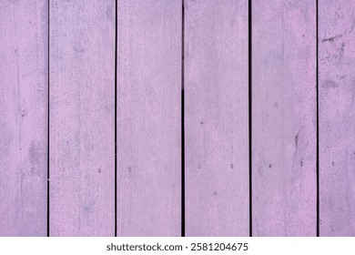 This image features a close-up view of light purple wooden planks arranged vertically, showcasing their textured surface and vibrant color. Perfect for backgrounds or artistic projects.