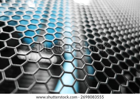 This image features a close-up view of a hexagonal wire mesh pattern, showcasing the intricate geometric design and metallic texture, perfect for industrial themes.