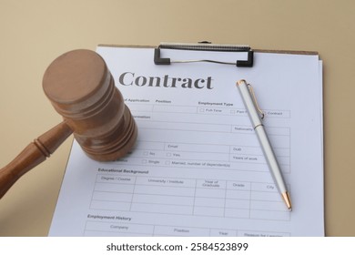 This image features a contract paper in a clipboard, a judge's hammer, and a pen on the table, representing legal agreements, authority, and documentation. Ideal for legal or business-related designs.