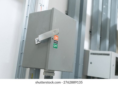 This image features an electrical control box with clear on and off labels. Ideal for illustrating safety and operational features in industrial settings.