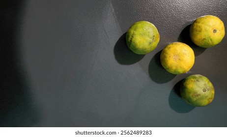 This image features fresh oranges, with their vibrant orange skin and glossy texture, arranged on a rustic wooden surface.