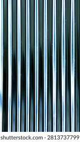 This image features a highly reflective, vertically corrugated or fluted surface. The texture consists of tight, parallel ridges and grooves that create a strong rhythmic pattern across the frame. Sunlight or bright ambient light catches the edges of the ridges, producing sharp, glowing white and pale blue linear highlights. The recessed grooves remain in deep shadow, varying from dark navy blue to near-black. The metallic or glossy finish distortion distorts the reflections slightly, giving the surface a sleek, modern, and industrial aesthetic with a distinct futuristic or sci-fi feel