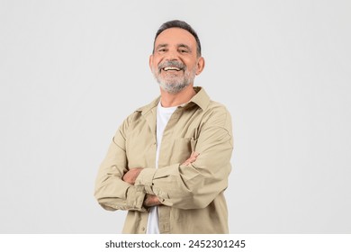 This image features a senior man laughing heartily with his arms crossed, embodying the joy and vigor of elderly individuals, isolated on white