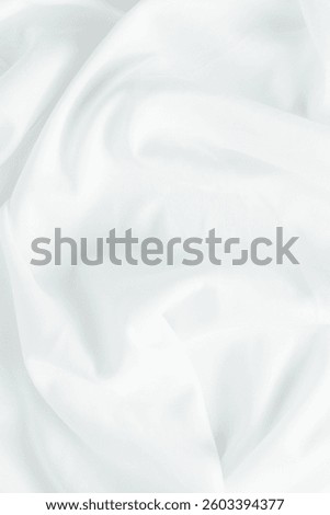 This image features a soft white fabric draped elegantly, offering a smooth and serene aesthetic. Perfect for backgrounds in design and decoration projects.