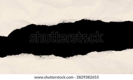 This image features torn paper with a dark central void exhibiting a textured surface and rough fragmented edges. The background is a neutral tone creating contrast with the void.
