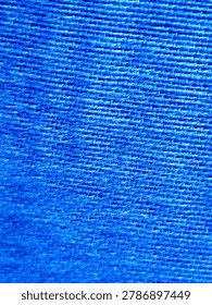This image highlights a classic plain-weave textile construction, commonly found in heavy-duty commercial fabrics like polyester canvas, tarp mesh, or cheesecloth material. The close-up angle reveals the tactile ribbed rows and subtle fiber glint, creating a vivid, consistent grid pattern across the composition. This texture can be used to illustrate material science concepts, industrial weaving processes, synthetic fiber production, textile manufacturing, or abstract cobalt blue background layouts.