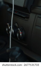 This image highlights the exceptional interior of a modern car, featuring userfriendly air conditioning controls, wellplaced vents, and an accessible phone charging cable