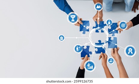 This image illustrates a collaborative effort in solving a puzzle, featuring hands and various business icons, emphasizing teamwork and innovative problem-solving strategies. Amity
