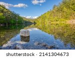 This image is the Mill Creek Lake in the Red River Gorge area of Daniel Boone National Forest in Slade, Kentucky. Off in the distance, the lake enters a underground cavern that can be explored.