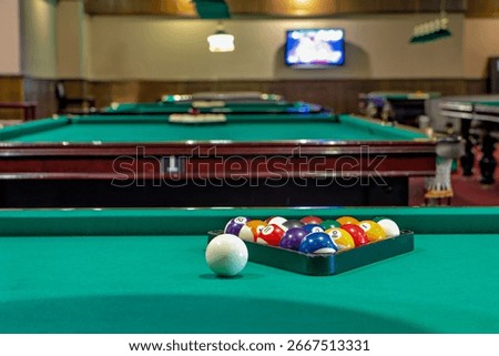 This is an image of a pool table with a rack of billiard balls on it