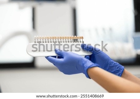 This image presents a close view of a dental shade guide, a tool used for precise color matching to ensure the best aesthetic outcome in dental treatments.