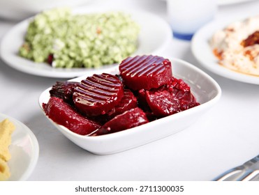 This image presents a diverse selection of Mediterranean and Greek-inspired dishes featuring traditional meze, fresh seafood, assorted fish plates, and beautifully prepared desserts, all arranged on a