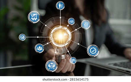 This image presents a lightbulb surrounded by various icons, symbolizing innovative business strategies, technology, and growth in a modern office setting. Crux
